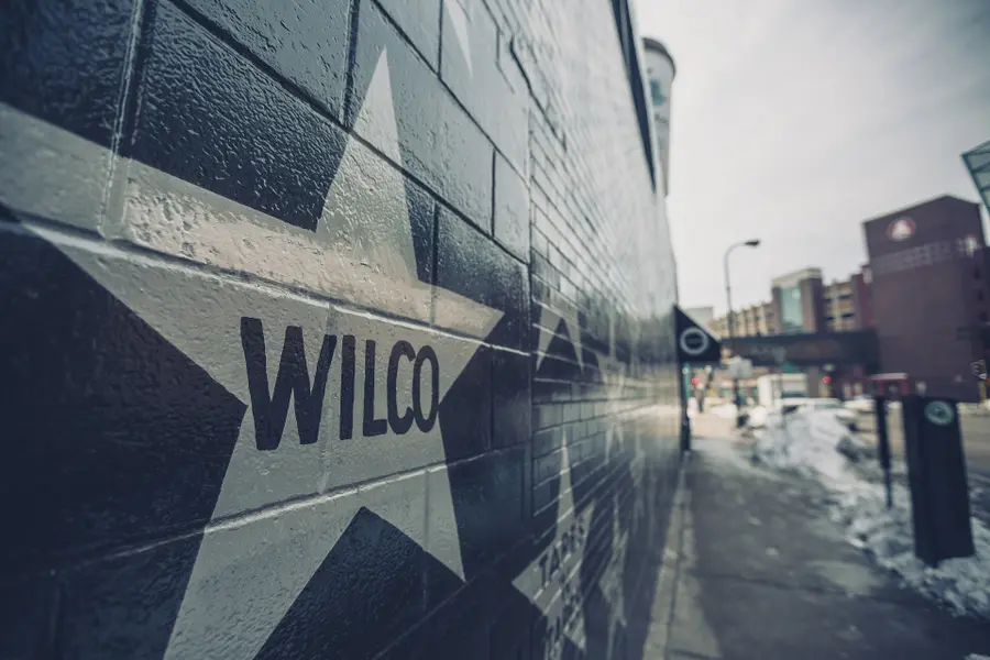 The Wilco star painted on the black brick wall of the First Avenue building, the same wall as the 7th St Entry's door, with downtown Minneapolis in the distance