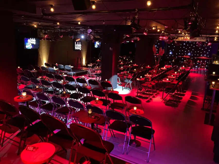 The Main Room at Comedy Club Haug in Rotterdam, with its stage and tables.