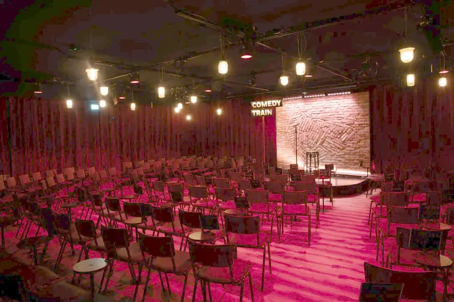 The empty club room of Comedytrain on the Westergas, with seats facing the stage