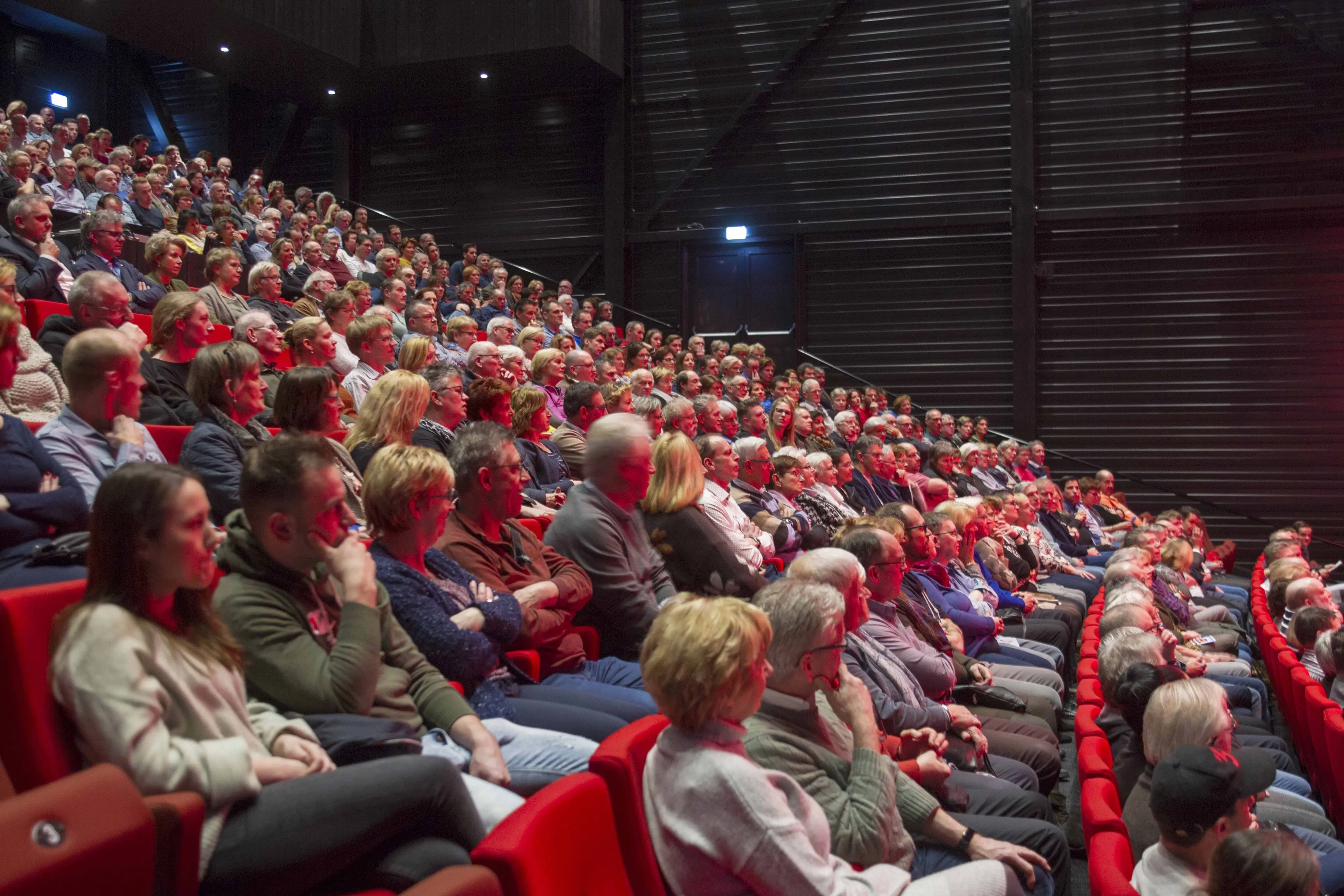 Audience in the Grote Zaal of De Blauwe Kei, the theatre's 696-seat main hall, during a performance.