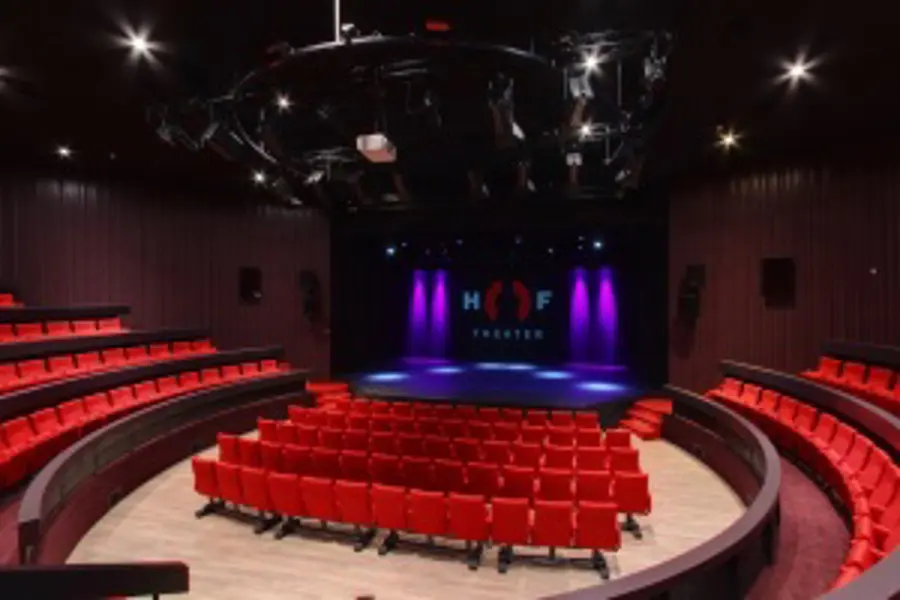 The empty theatre hall of the HOFtheater in Raalte, with its rows of seats.