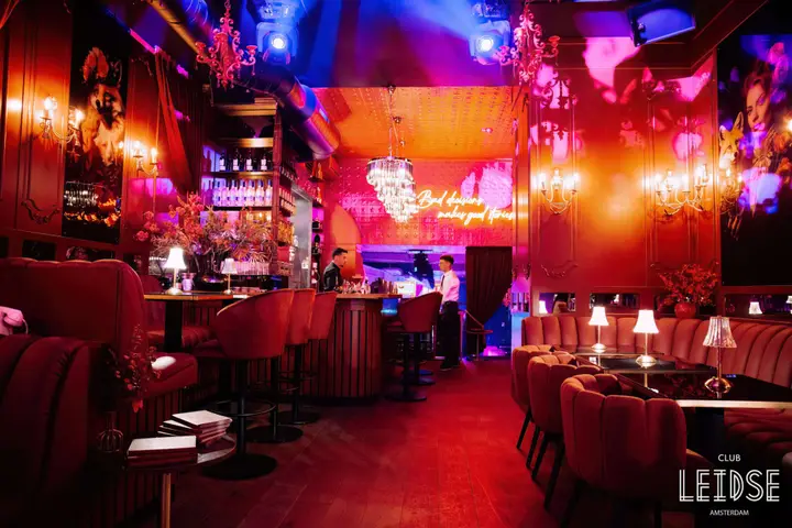 A lounge corner at Club Leidse, with seating and warm interior lighting