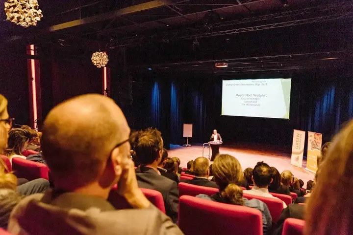 Audience seated on the tribune of the Lindenbergzaal during a presentation