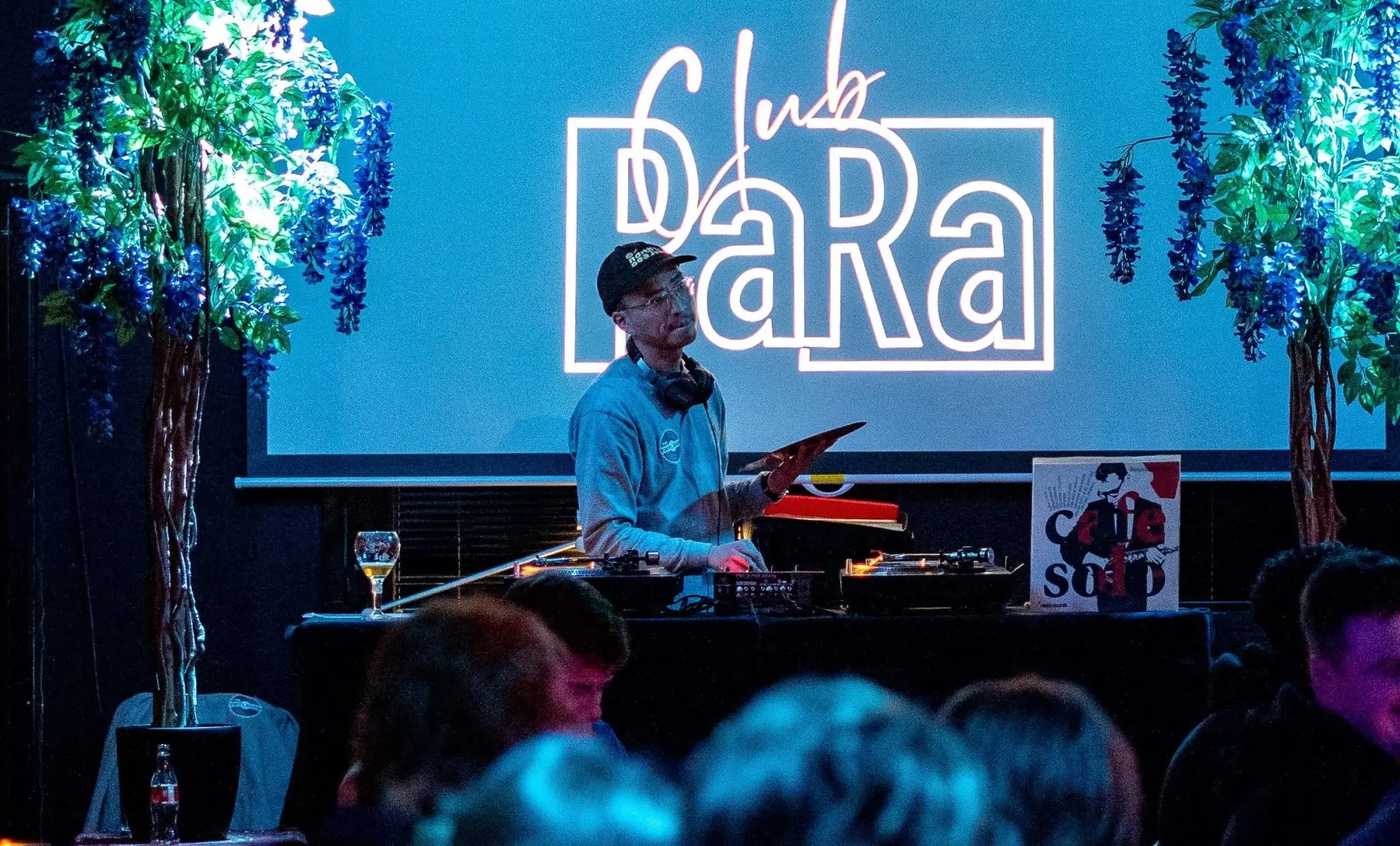 A Club PARA night at Paradox in Tilburg, with people sitting with drinks in the venue's living-room-style hall.