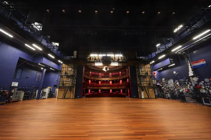 The view from the back of the stage across the Schouwburgzaal, with artists' props on the right wall