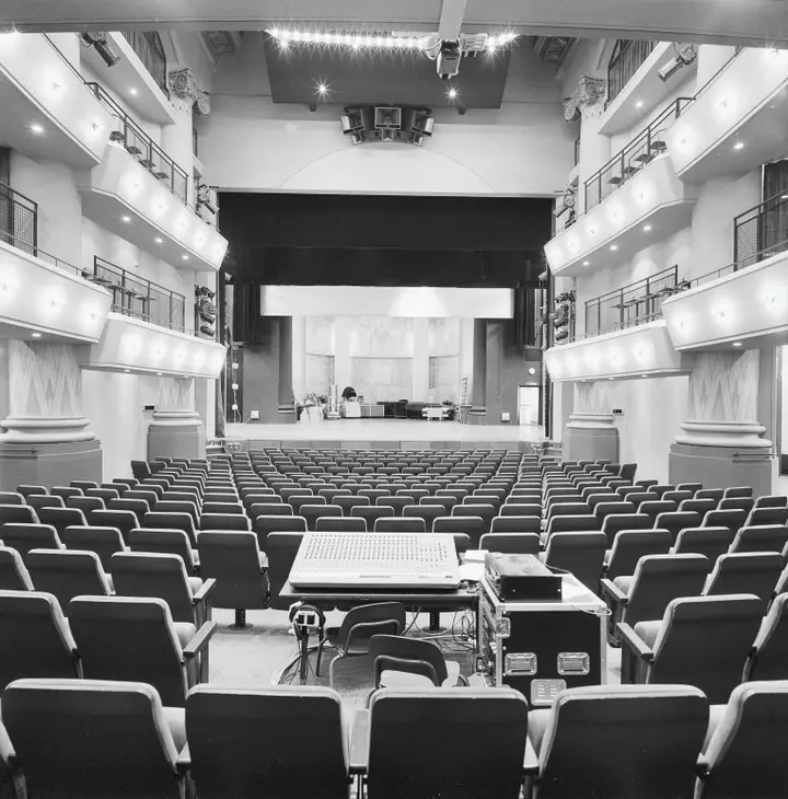 Interior overview of the former church hall of Theater De Maagd, looking east towards the stage.