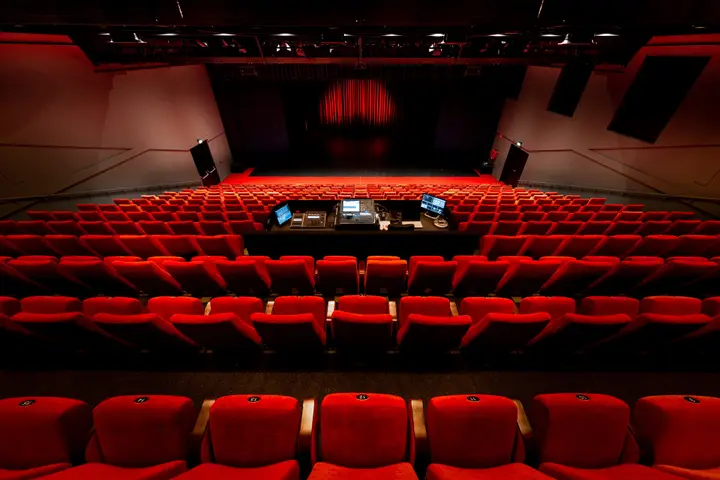 The Nestlézaal at Veluvine, the main theatre hall with its red upholstered seats